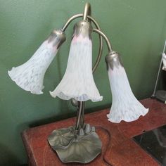 This pretty Lilypad based lamp has a delicate lily shaped white glass shade on all 3 arms.  16" to the highest arm.   Lilypad base is 7" with a touch of patina.   Inline switch.  Candle light type bulb.  No cracks or chips.  Previously loved vintage. Please read my shop policies which are on the bottom of the page of the link https://www.etsy.com/shop/LuRuUniques And ask any questions before making a purchase. By purchasing this, you agree that you have read the description and know the conditions of this item. 4-548MLC(24-4230) Lily Lamp, Dream Room Inspiration, Candle Light, Accent Lamp, Aesthetic Room Decor, Live Light, Lily Pads, Aesthetic Room, Dream Room