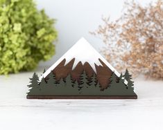 a small wooden mountain with trees on it