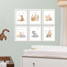 four winnie the pooh wall decals in a child's room with a crib