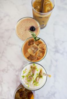 four different types of drinks on a table