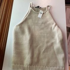 Never Worn. Tan Sweater Tank. Chic Winter Vacation Tops, Cozy Cotton Tops For Beach, Cozy Cotton Beach Top, Cozy Winter Vacation Tops, Chic Winter Cotton Crop Top, Chic Cotton Crop Top For Winter, Casual Knitted Crop Top For Winter, Winter Vacation Knitted Tops, Casual Cream Knitted Tops