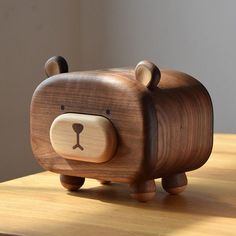 a wooden toy bear sitting on top of a table