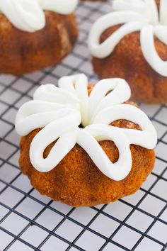 some kind of pastry with icing on it sitting on a cooling rack, ready to be eaten