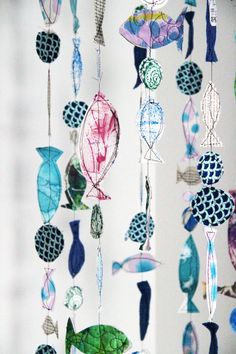 a group of fish and sea creatures hanging from strings