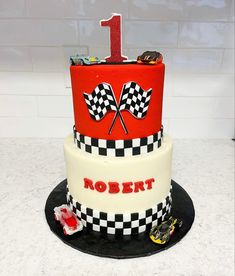 a three tiered cake decorated with racing flags