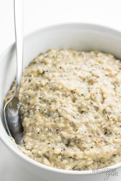 a white bowl filled with oatmeal and a spoon