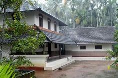 a white house surrounded by trees and greenery