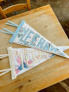 two pennants sitting on top of a wooden table