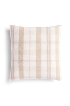 a beige and white plaid pillow on a white background