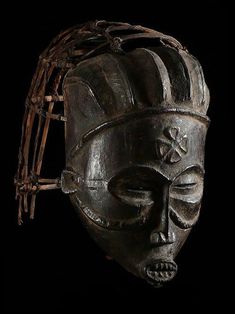 an african mask is shown against a black background