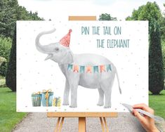 an elephant with a party hat on it's head is standing in front of a birthday card