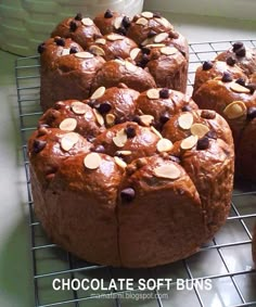 chocolate soft buns with almonds on a cooling rack next to other muffins