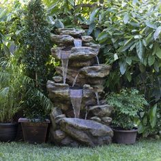 there is a water fountain in the garden