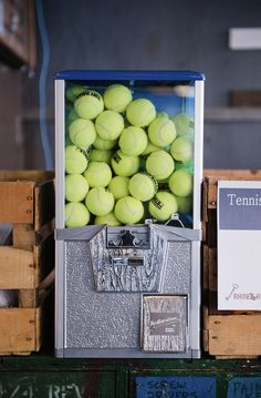 tennis balls are stacked in a machine to be sold