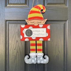 a door hanger with a elf holding a sign that says, steps it christmas