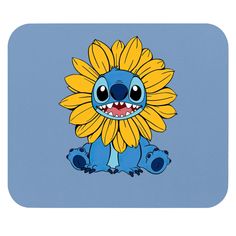 a blue and yellow cartoon character with big eyes sitting on the ground next to a flower