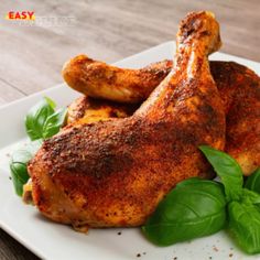 chicken with basil leaves on a white plate