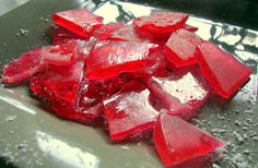 some red pieces of ice on a table