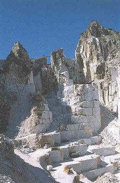 the ruins are built into the side of the mountain, with no people around them