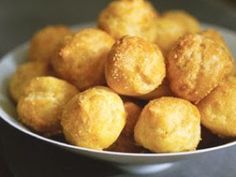 a white bowl filled with fried food on top of a table