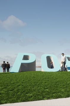 people standing in front of the word poop on top of a grass covered field