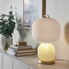 a white lamp sitting on top of a table