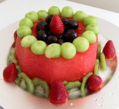 a watermelon and kiwi fruit cake on a plate