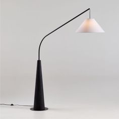 a black lamp with a white shade on it