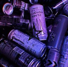 an image of many different types of cans and bottles on the floor with purple lighting