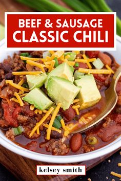 a bowl of beef and sausage chili with avocado on top, in a white bowl