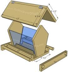 a wooden birdhouse with the door open and its roof opened to show it's contents