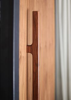 a wooden door handle is seen in this image