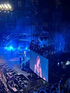 a concert scene with people on stage and one person in the middle of the stage