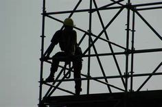 a construction worker is working on the scaffolding