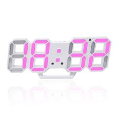 an alarm clock with pink leds on it's face and numbers displayed in the middle