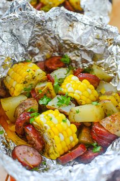 corn on the cob and sausage wrapped in foil