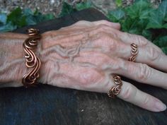 an older woman's hand with two rings on her left and one ring on her right