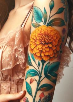 a woman's arm with an orange flower on it