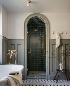 a white bath tub sitting next to a walk in shower