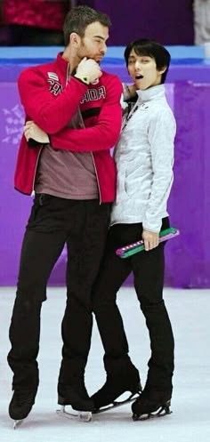 two people standing next to each other on a ice rink