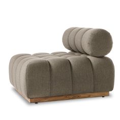 a grey couch with four round cushions on the back and one wooden frame, sitting in front of a white background