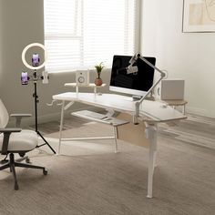 a chair and desk with a computer on it in an office area, next to a window