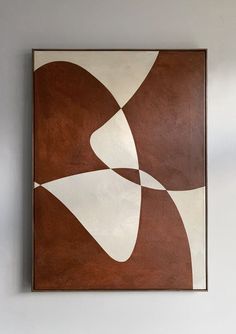 a brown and white painting hanging on the wall