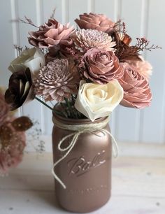 a mason jar filled with pink and white flowers