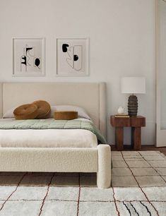 a white bed sitting in a bedroom on top of a rug