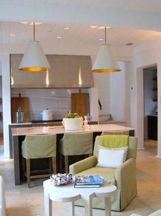 a living room filled with lots of furniture next to a kitchen and dining room table