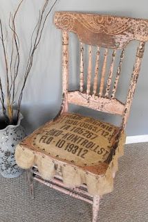 an old wooden chair with writing on it