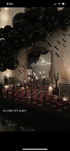 an image of a party with balloons and candles on the table in front of a mirror