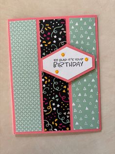 a handmade birthday card with confetti and streamers on black, green, white and pink