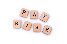 the word pay rise spelled with scrabble blocks